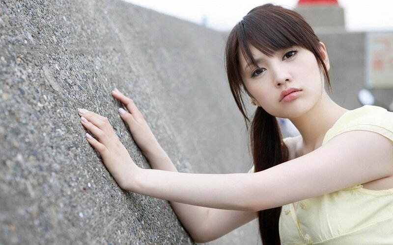 woman leaning on concrete wall