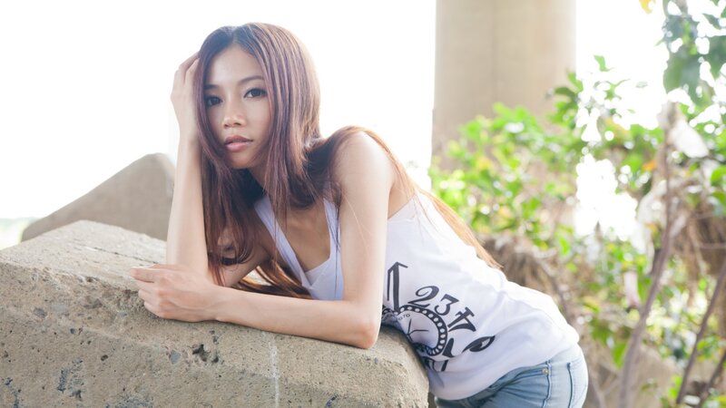 woman leaning on concrete wall