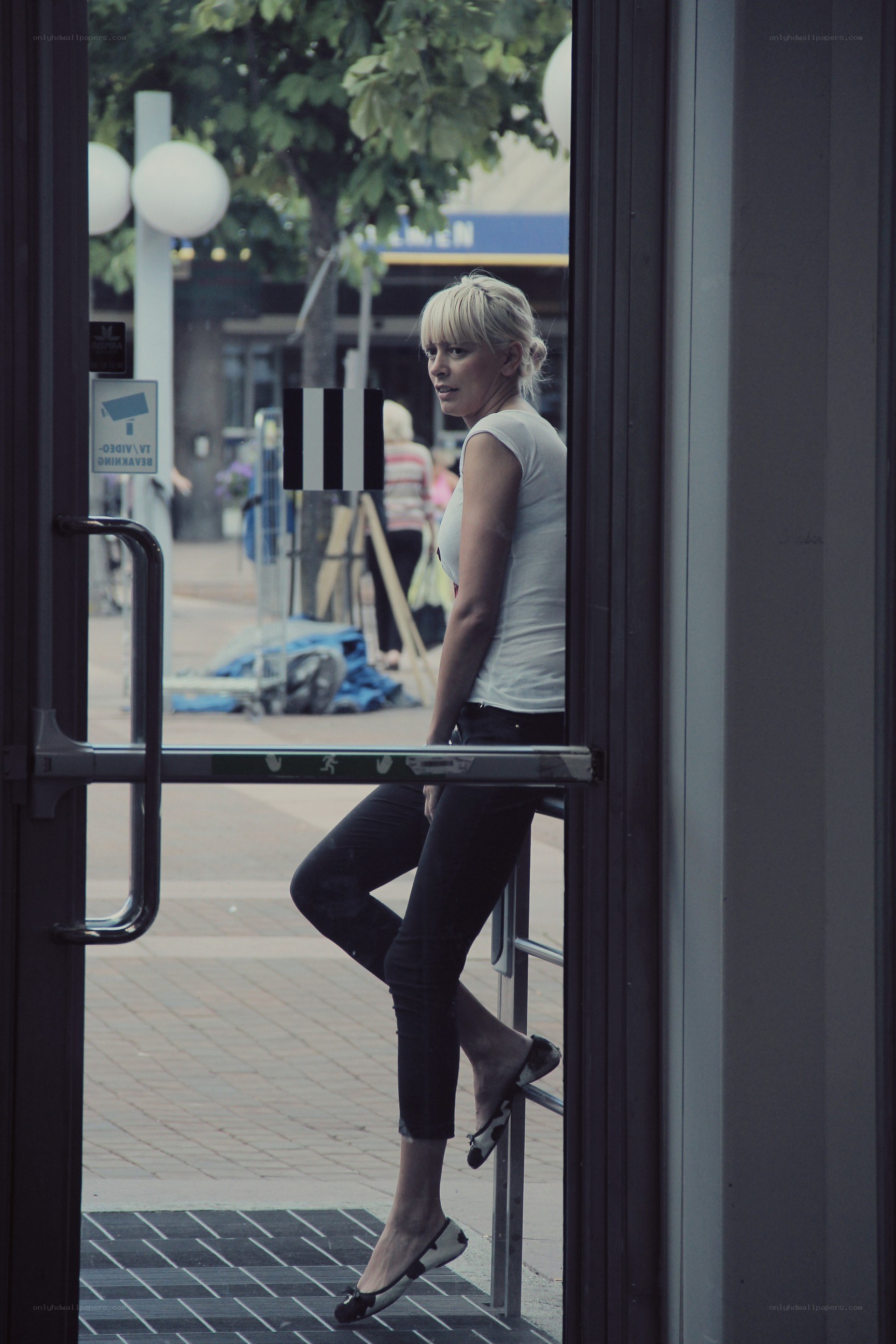 Woman leaning on door frame