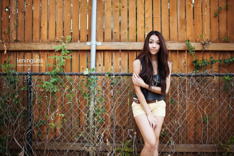 woman leaning on fence