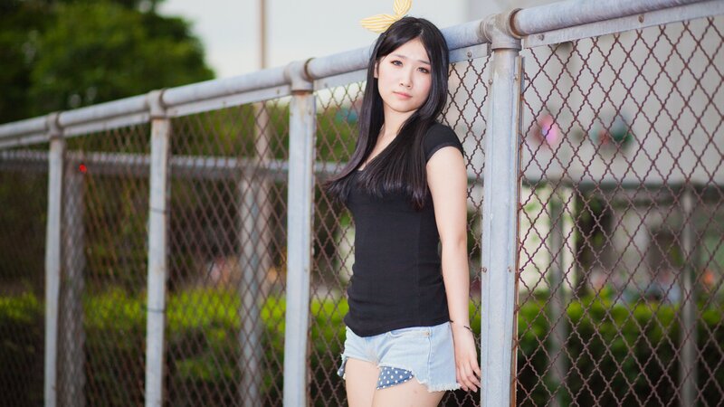 woman leaning on fence