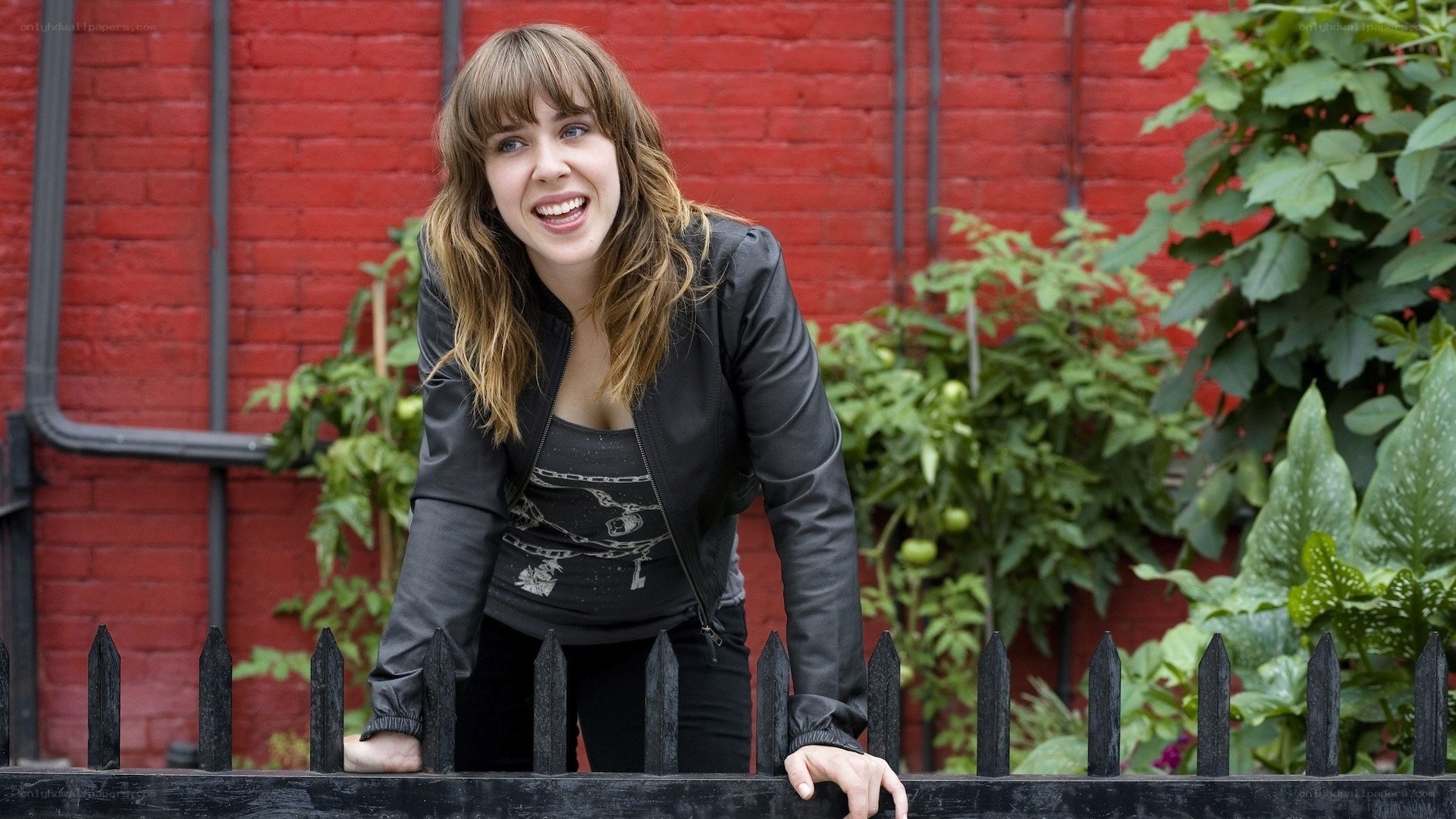 woman leaning on fence smiling