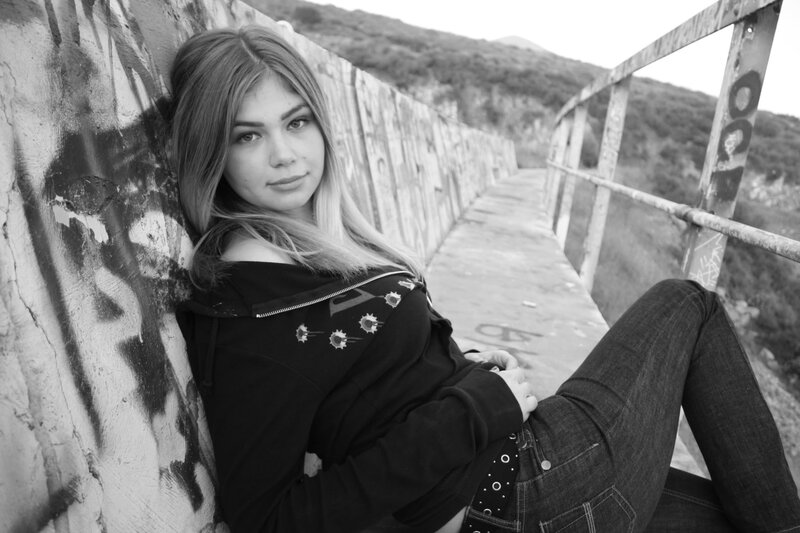 woman leaning on graffiti wall