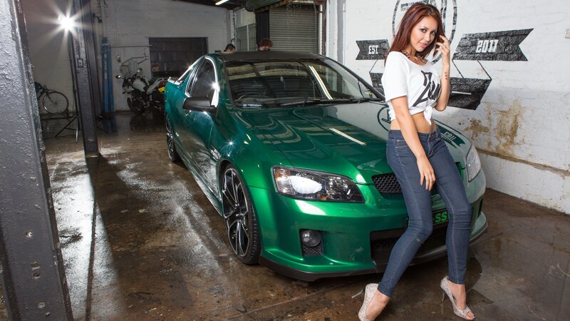 Woman Leaning on Green Car — Dramatic, Photograph