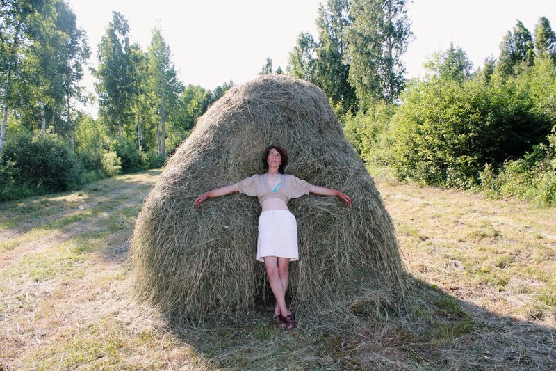 Woman Leaning on Hay Bale — Green
