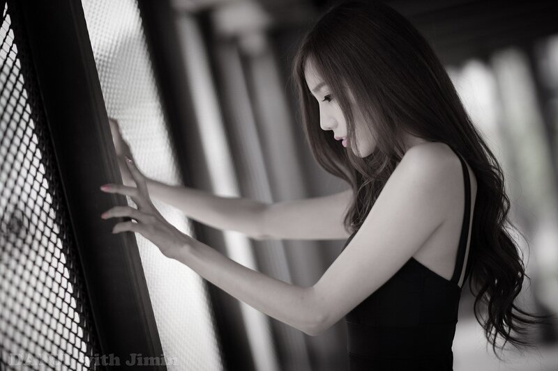 woman leaning on mesh fence