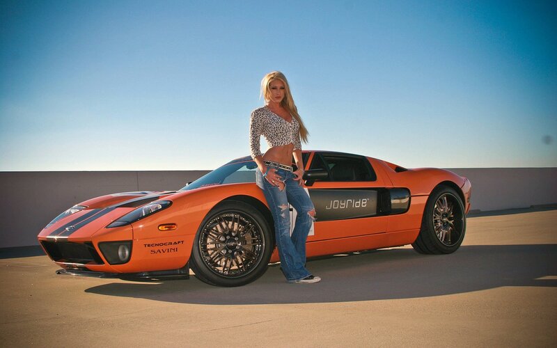Woman Leaning on Orange Car — Dramatic, Afternoon, Photograph