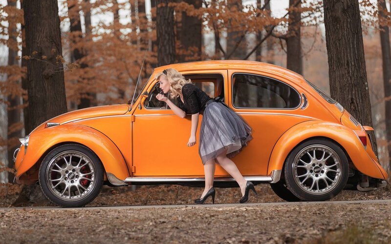 Woman Leaning on Orange Car — Serene