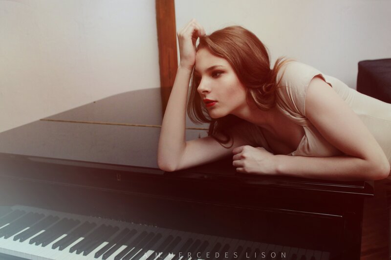 woman leaning on piano