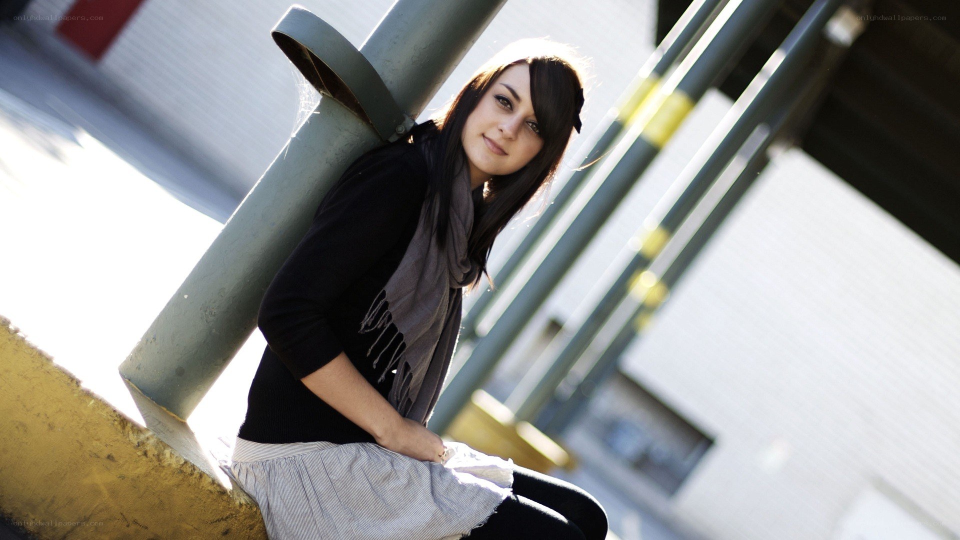 woman leaning on pole