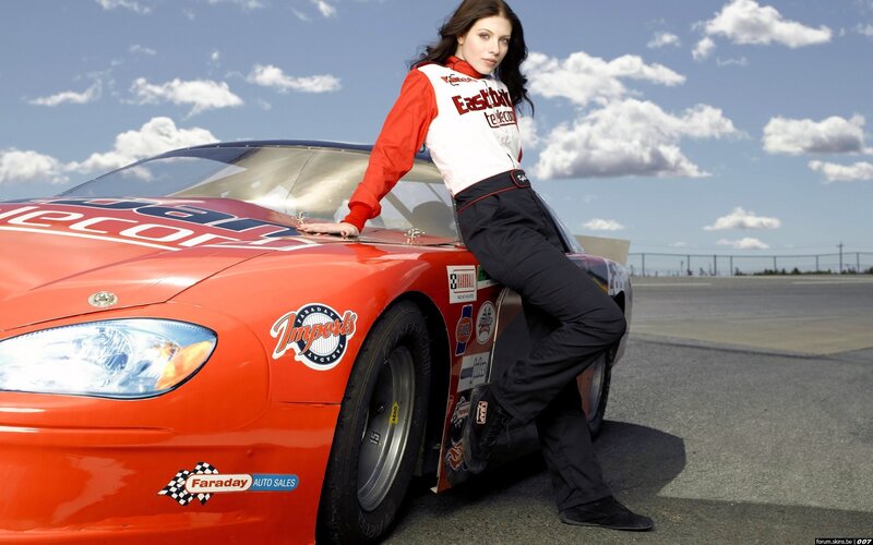 woman leaning on race car