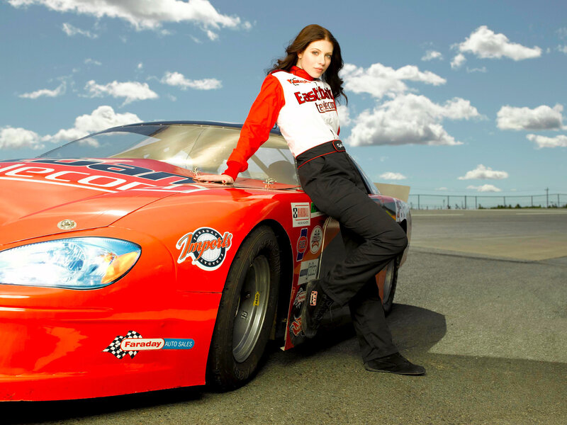 woman leaning on race car