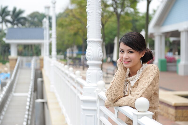 Woman Leaning on Railing — Beige