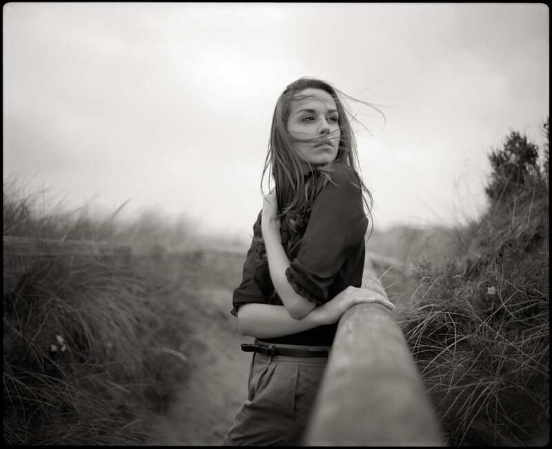 Woman Leaning on Railing — Black, Moody