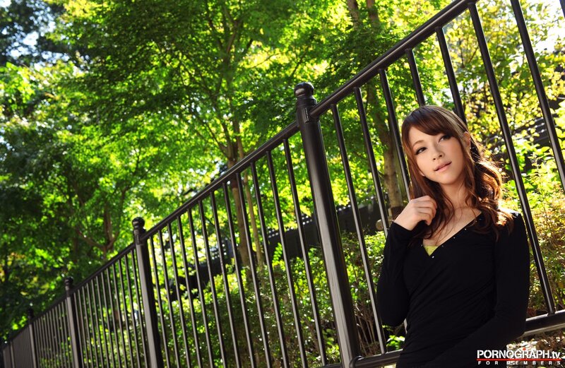 woman leaning on railing outdoors