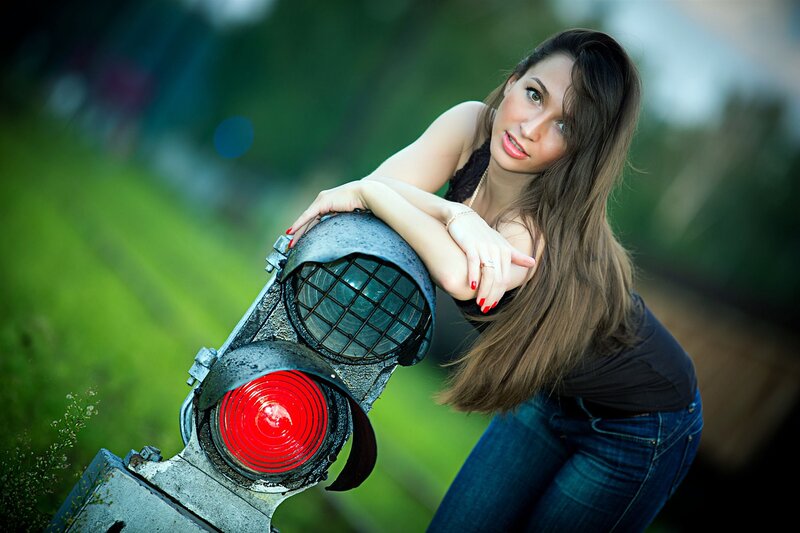 woman leaning on railway signal
