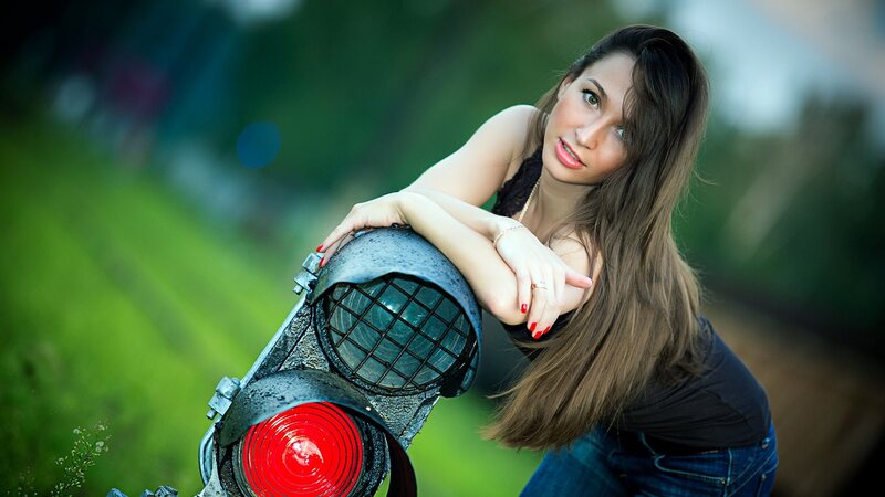 woman leaning on railway signal