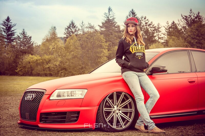 woman leaning on red car
