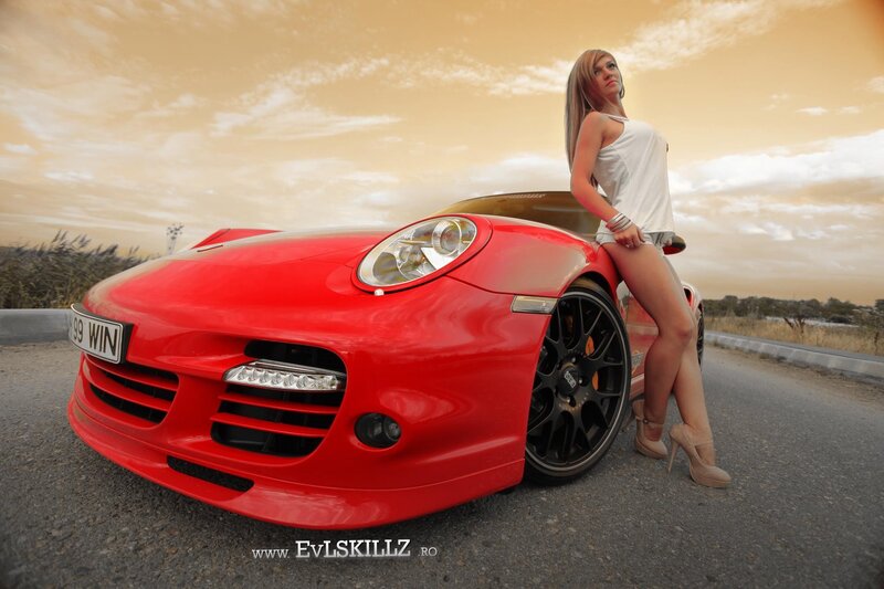 Woman Leaning on Red Car — Dramatic, Sunset
