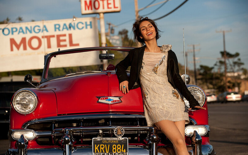 Woman Leaning on Red Car — Relaxed, Sunset