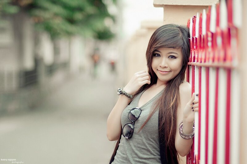 woman leaning on red fence