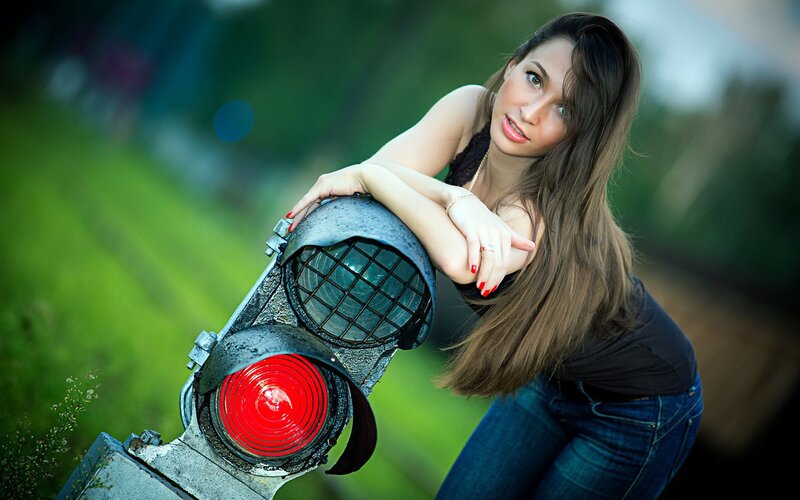 woman leaning on red signal light