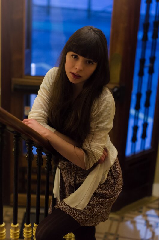 woman leaning on staircase railing
