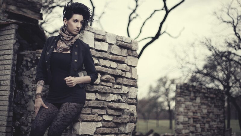 Woman Leaning on Stone Wall — Black, Dramatic