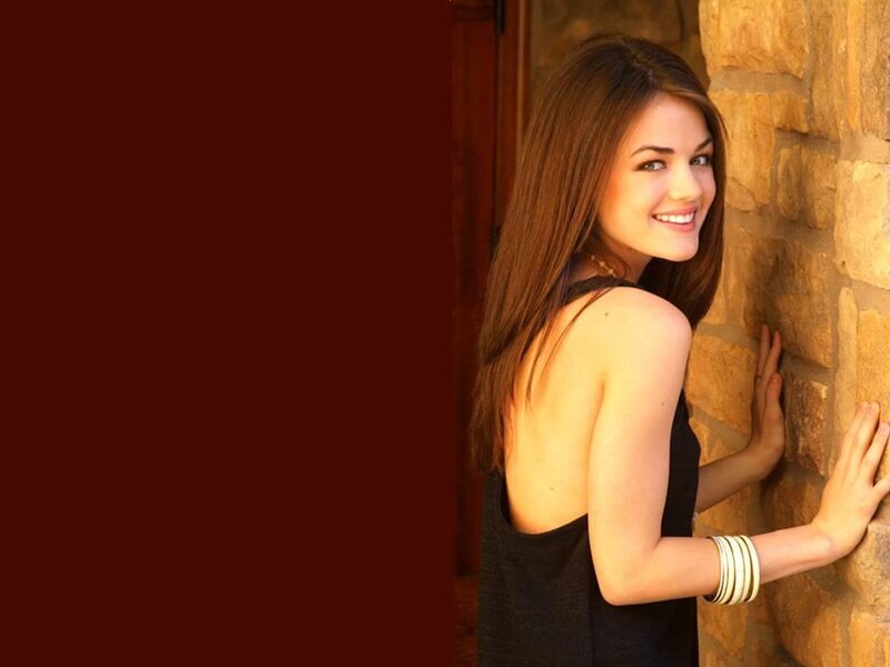 Woman Leaning on Stone Wall — Brown, Friendly