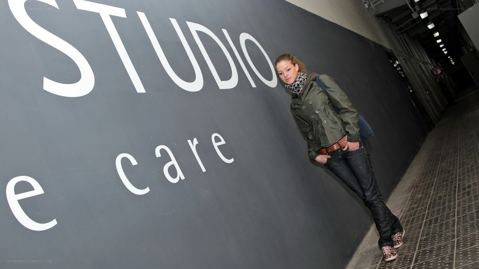 woman leaning on studio wall