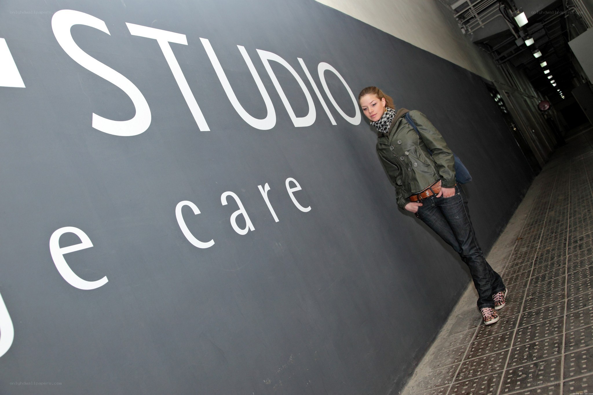 woman leaning on studio wall