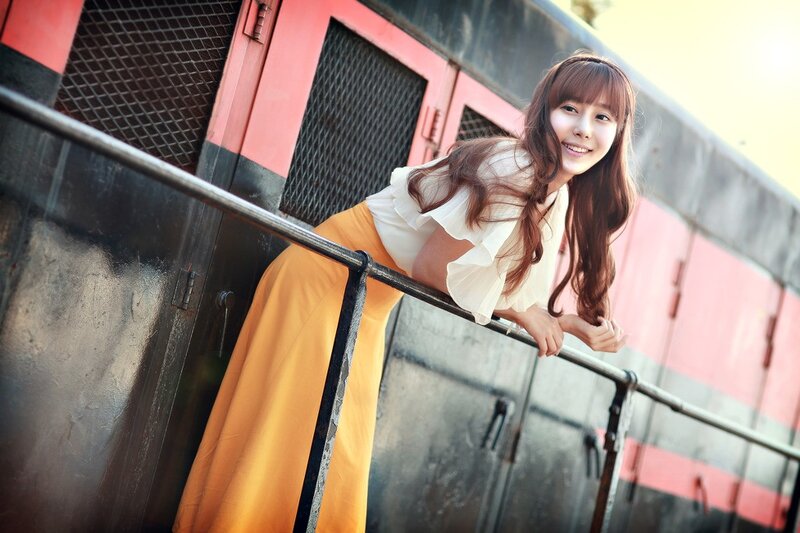 woman leaning on train railing