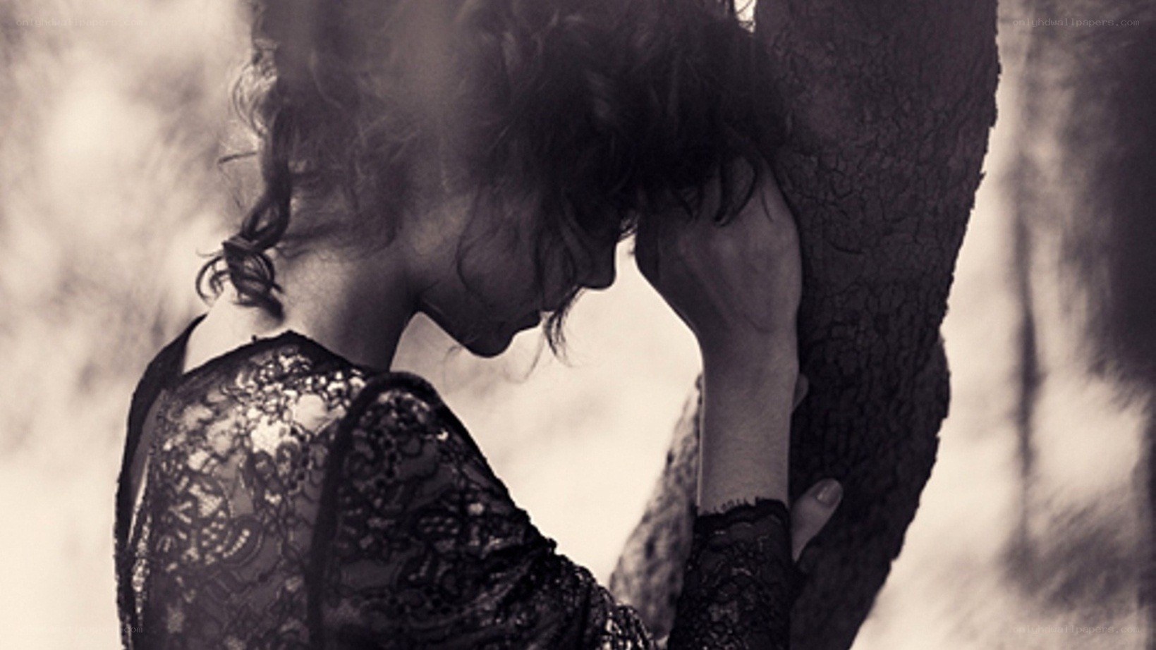woman leaning on tree