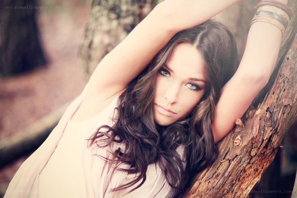 woman leaning on tree