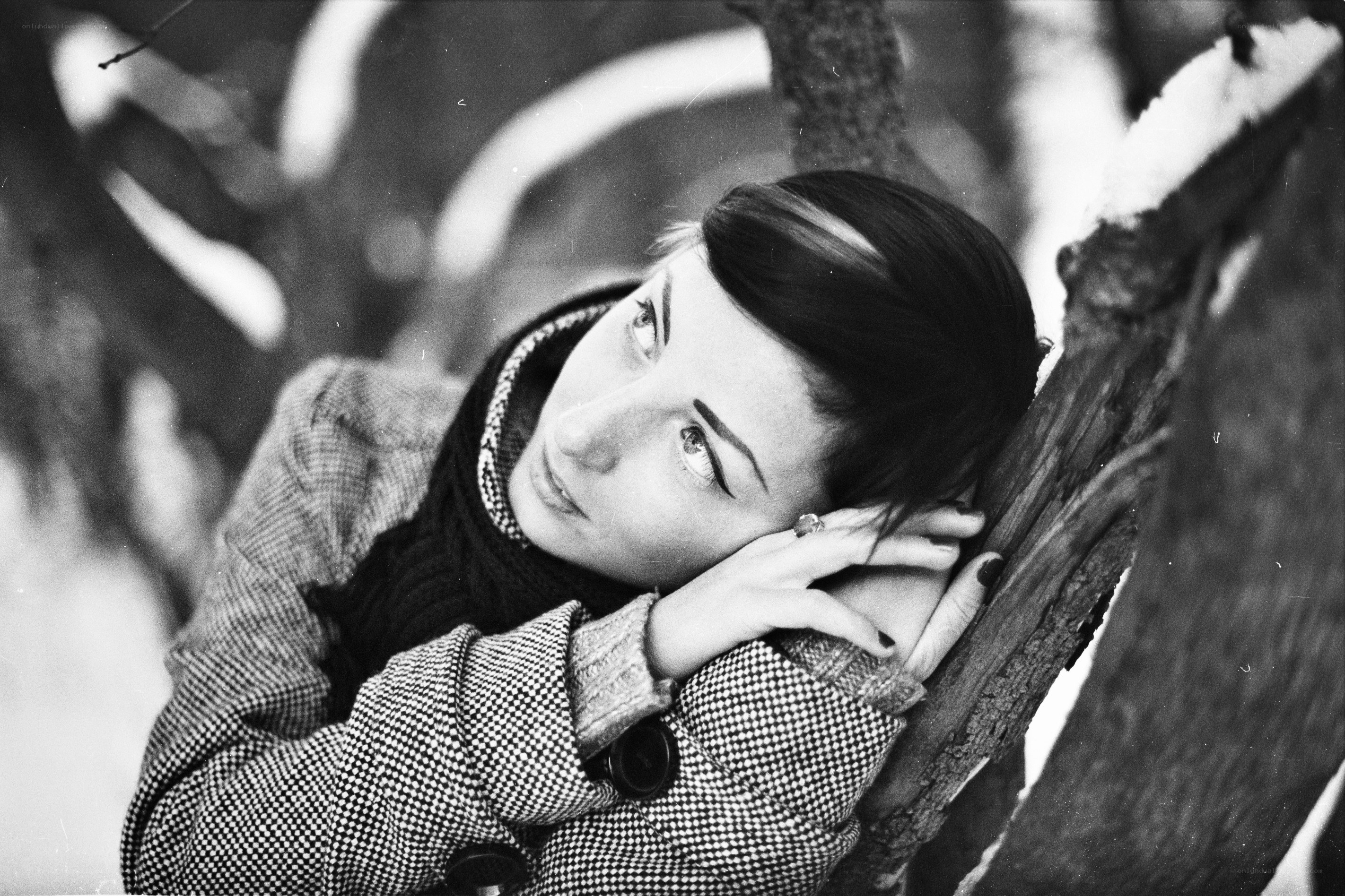 woman leaning on tree