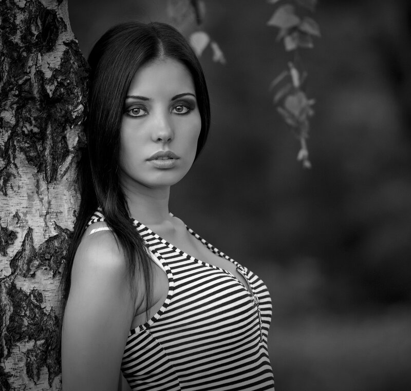 Woman Leaning on Tree — Black, Serious