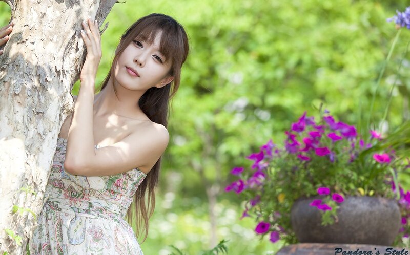 Woman Leaning on Tree — Green, Serene, Afternoon, Photograph, Flowers