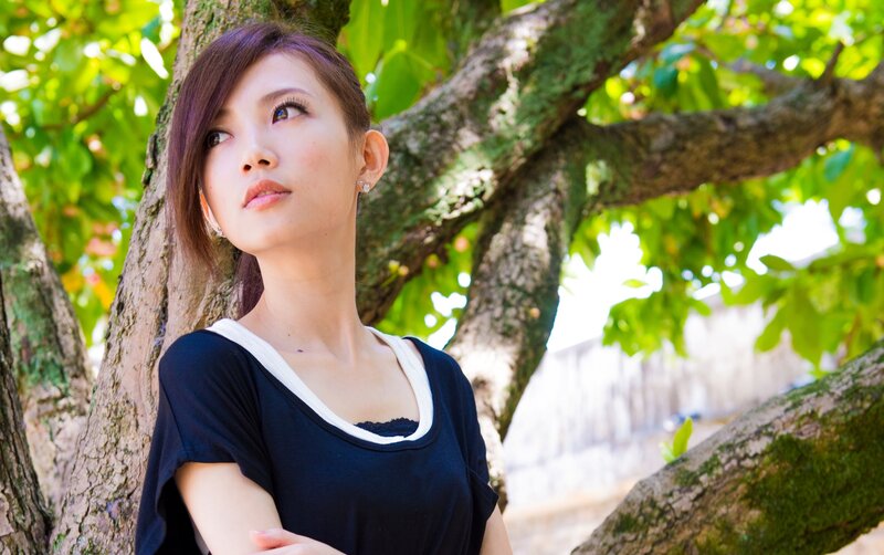 Woman Leaning on Tree — Green, Serene, Afternoon, Photograph, Leaves