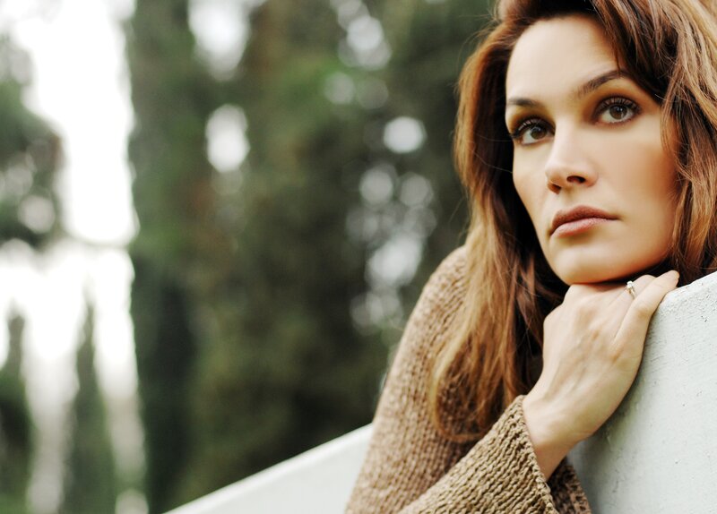 woman leaning on wall outdoors