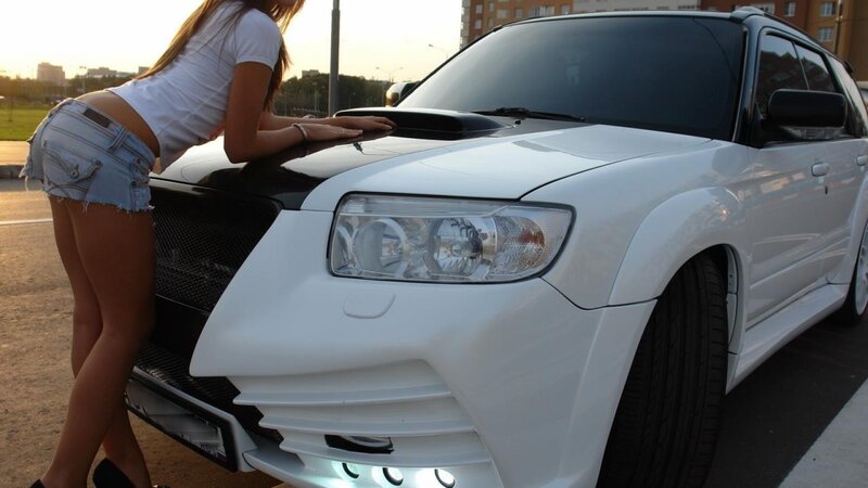 woman leaning on white car