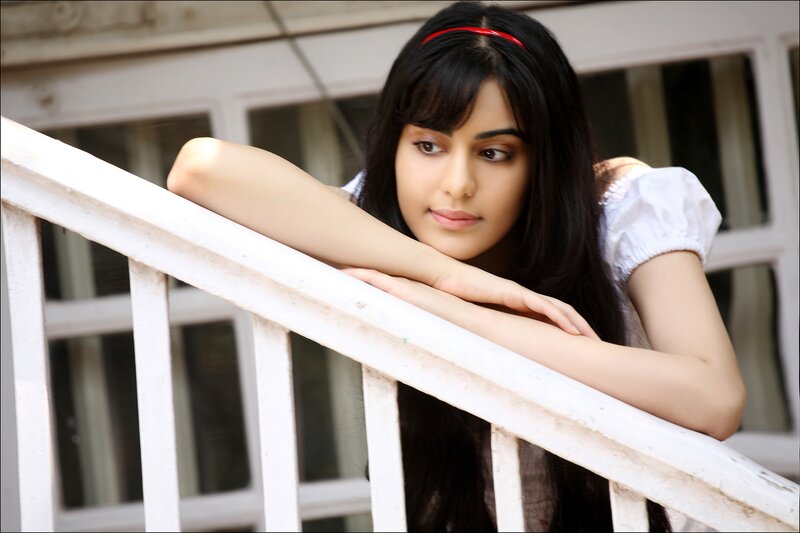 woman leaning on white railing