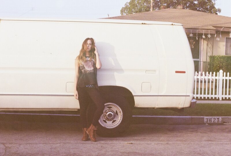 woman leaning on white van
