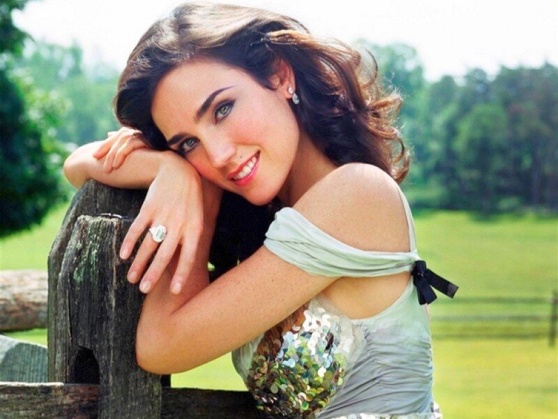 woman leaning on wooden fence