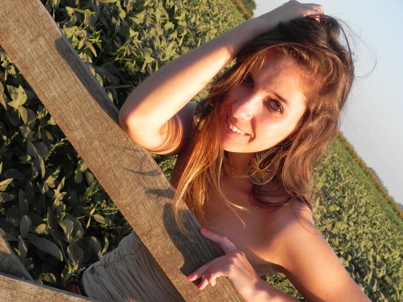 woman leaning on wooden fence