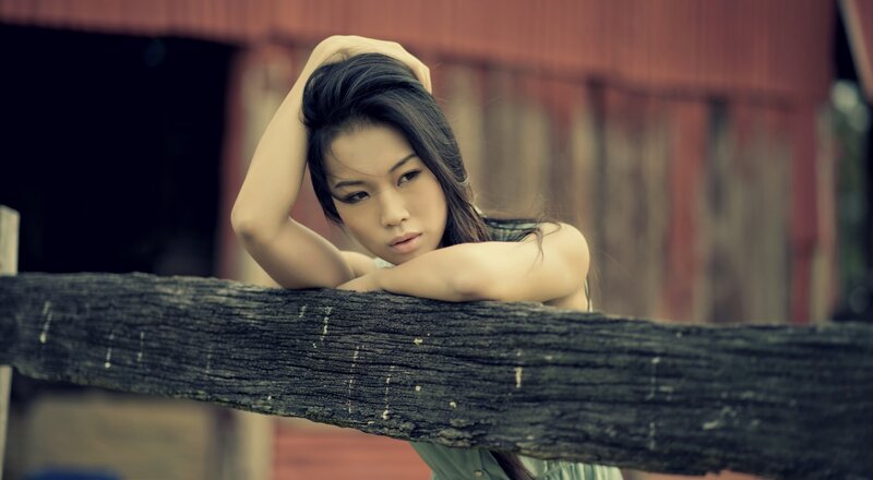 Woman Leaning on Wooden Rail