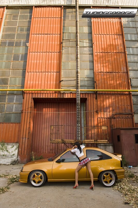Woman Leaning on Yellow Car — Dramatic, Afternoon, Photograph, Building