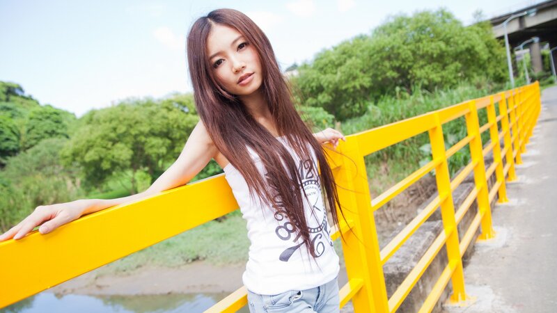 woman leaning on yellow railing
