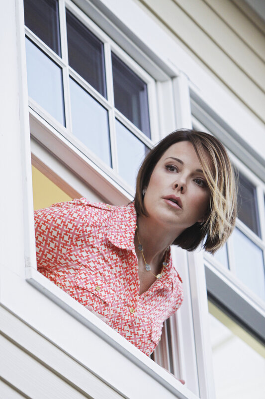 woman leaning out of window