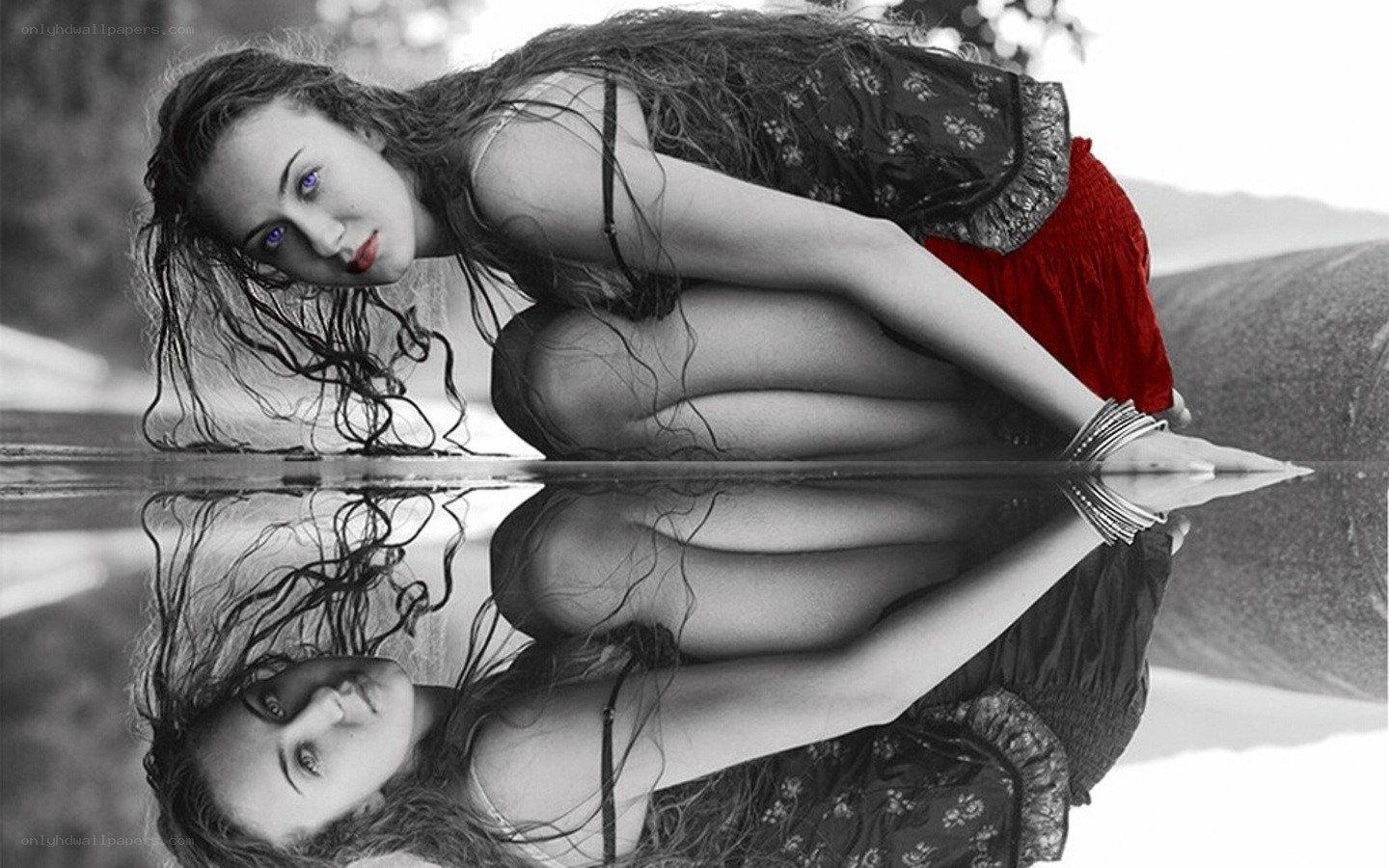 woman leaning over water reflection