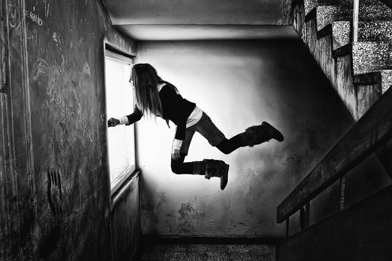 Woman leaping in stairwell